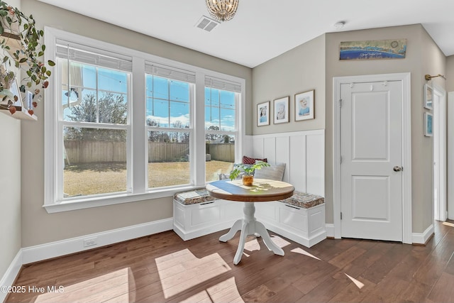 dining room featuring visible vents, a wainscoted wall, dark wood-type flooring, breakfast area, and baseboards