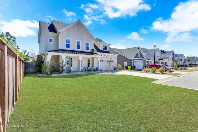 view of front facade with board and batten siding, a front lawn, a residential view, concrete driveway, and a standing seam roof