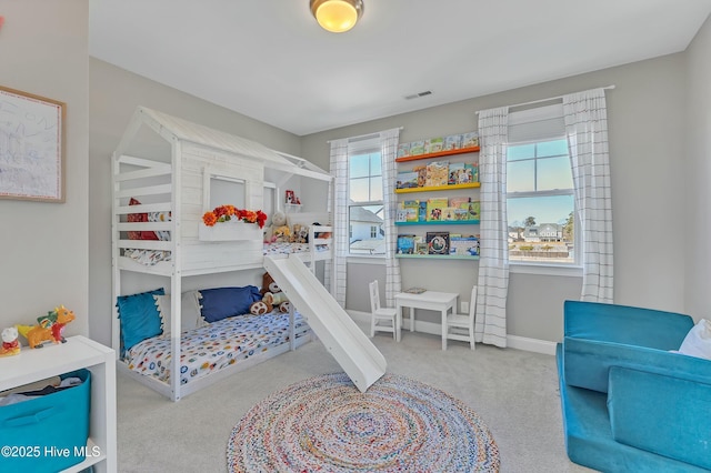 carpeted bedroom featuring visible vents and baseboards