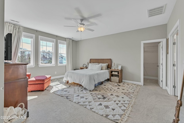 bedroom featuring visible vents, light carpet, and baseboards