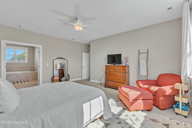 carpeted bedroom featuring visible vents, baseboards, connected bathroom, and a ceiling fan