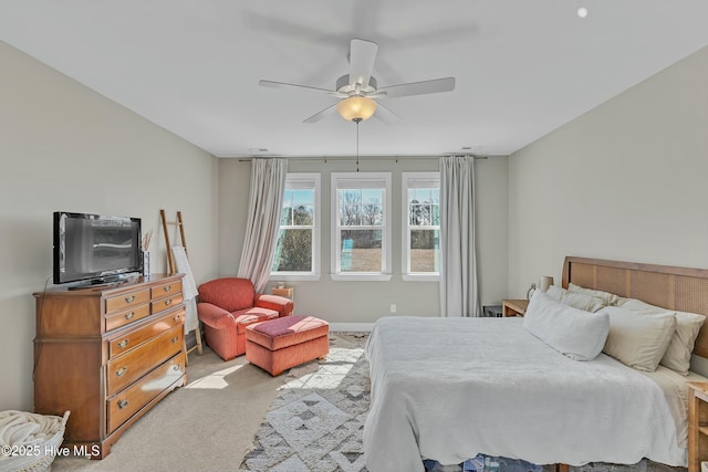 bedroom with light carpet and a ceiling fan