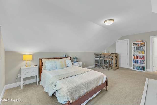 bedroom with baseboards, lofted ceiling, and carpet floors