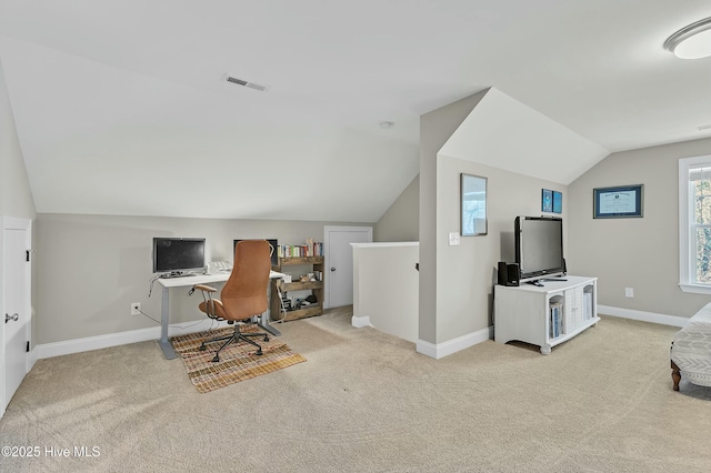 carpeted home office featuring visible vents, baseboards, and lofted ceiling