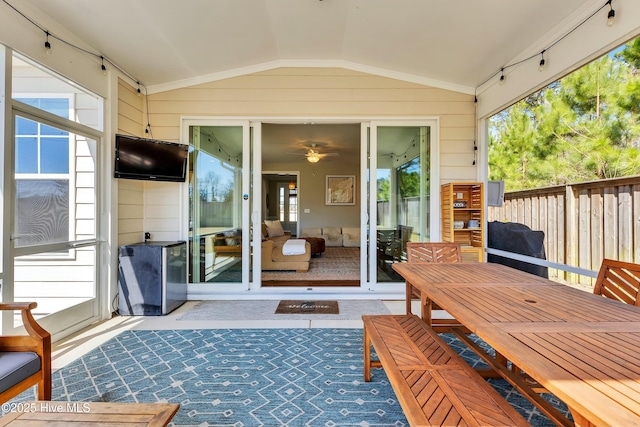 wooden terrace featuring fence, outdoor dining space, and a patio area