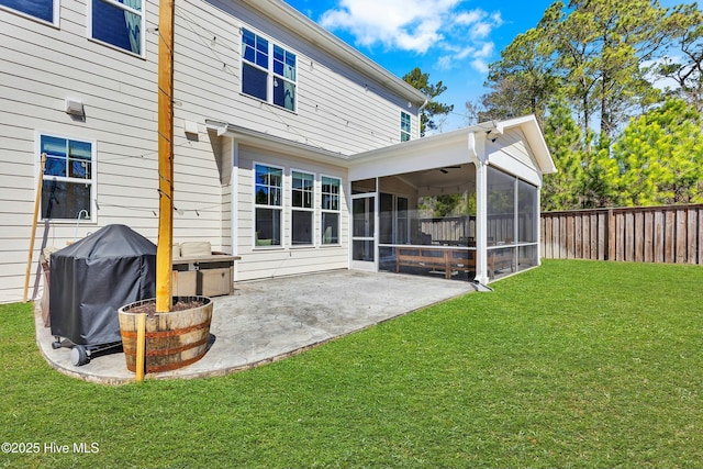 rear view of property with a patio area, a fenced backyard, a yard, and a sunroom