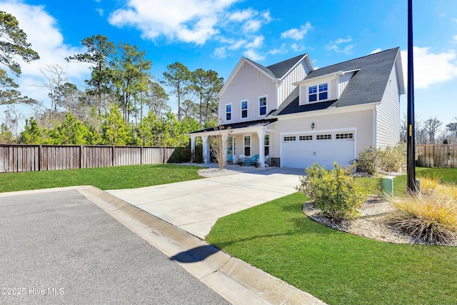 modern inspired farmhouse featuring a front lawn, fence, concrete driveway, roof with shingles, and a garage