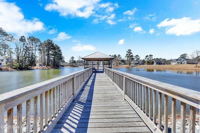 view of dock with a gazebo and a water view