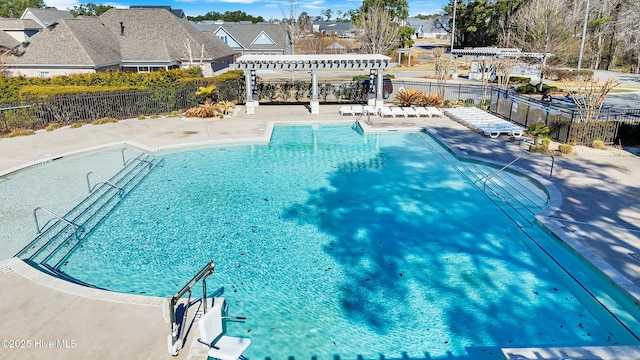 community pool featuring a pergola, a patio, and fence