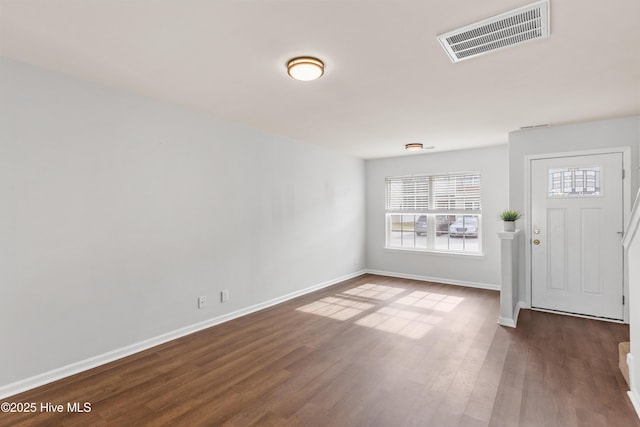 entryway featuring wood finished floors, visible vents, and baseboards