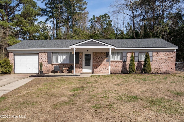 single story home with a front yard, brick siding, driveway, and an attached garage