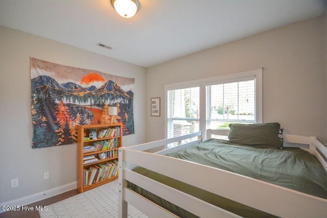 bedroom with visible vents and baseboards