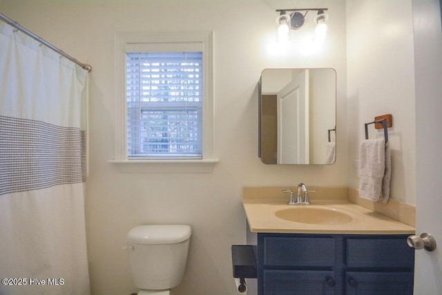 bathroom featuring toilet and vanity