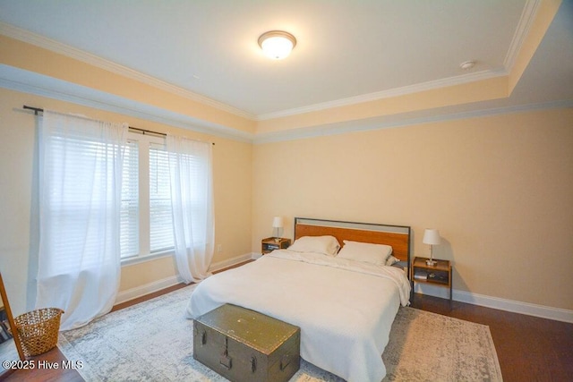 bedroom with crown molding, baseboards, and wood finished floors