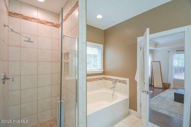 full bathroom with a shower stall, a bath, tile patterned floors, and a wealth of natural light