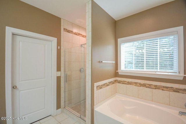 full bath with tile patterned flooring, a garden tub, and a shower stall