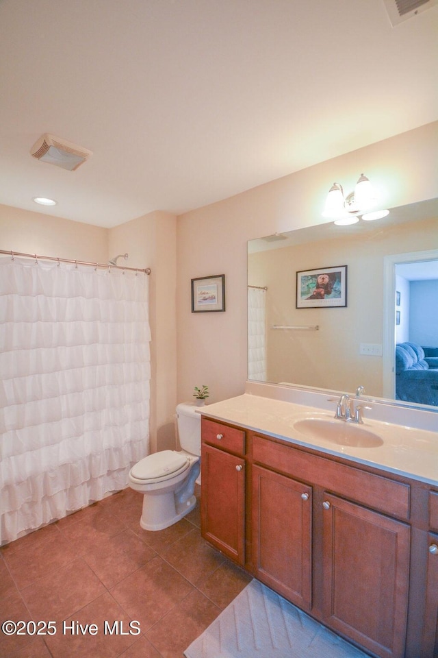 bathroom with tile patterned floors, visible vents, toilet, and vanity