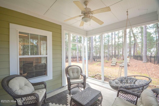 sunroom / solarium featuring a ceiling fan