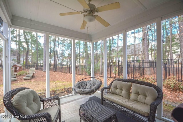 sunroom featuring a ceiling fan and a wealth of natural light