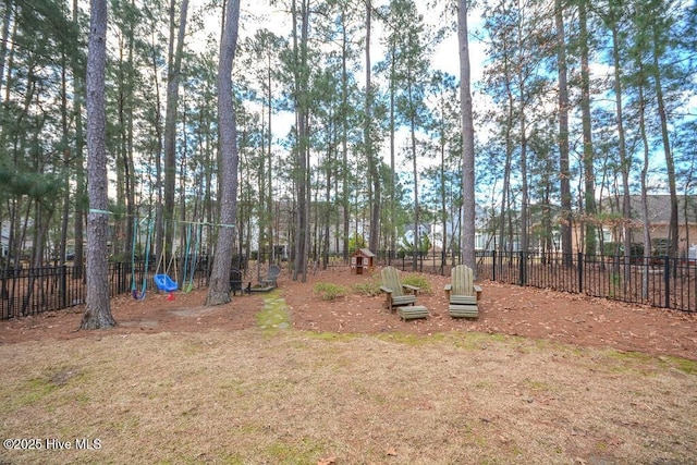 view of yard with fence and playground community