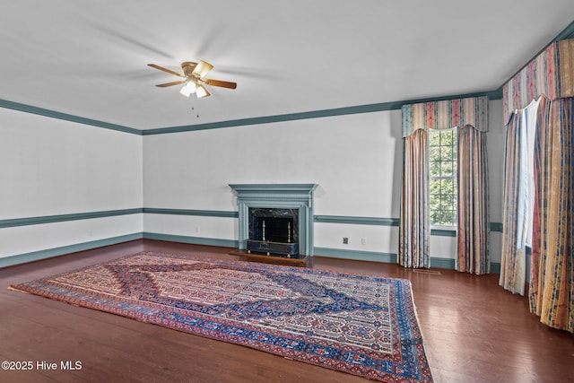 unfurnished living room featuring wood-type flooring, ceiling fan, and a high end fireplace