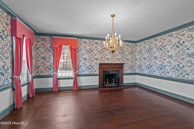 unfurnished living room with wood finished floors, a wainscoted wall, a premium fireplace, and wallpapered walls