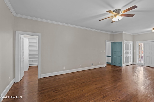 unfurnished bedroom featuring ornamental molding, baseboards, and wood finished floors