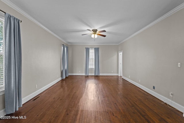 spare room featuring baseboards, visible vents, and wood finished floors