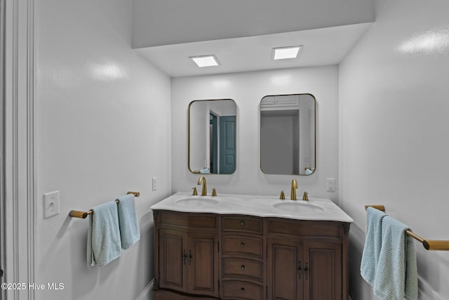 bathroom featuring a sink and double vanity