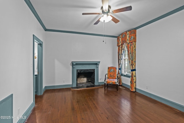 unfurnished living room with ornamental molding, a high end fireplace, ceiling fan, baseboards, and hardwood / wood-style flooring