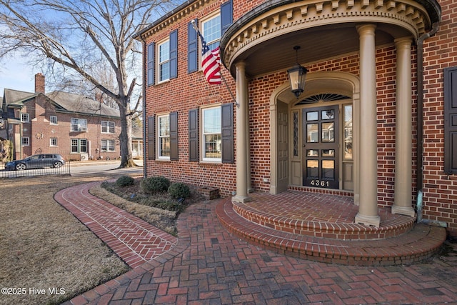 property entrance featuring brick siding