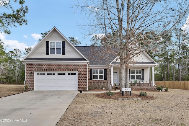 view of front of house with a garage, fence, concrete driveway, and brick siding