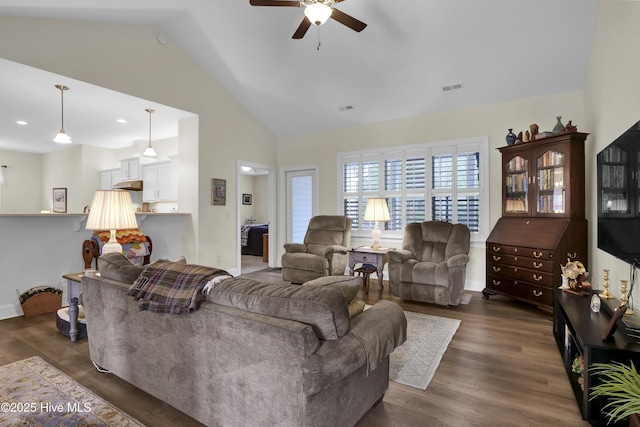 living room featuring visible vents, dark wood-type flooring, a ceiling fan, high vaulted ceiling, and baseboards