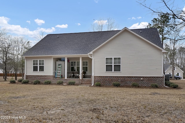 view of front of house with covered porch and a shingled roof