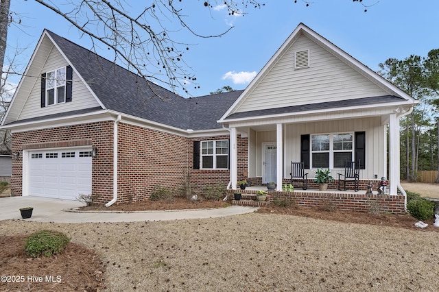 view of front of house with a porch, brick siding, driveway, roof with shingles, and board and batten siding