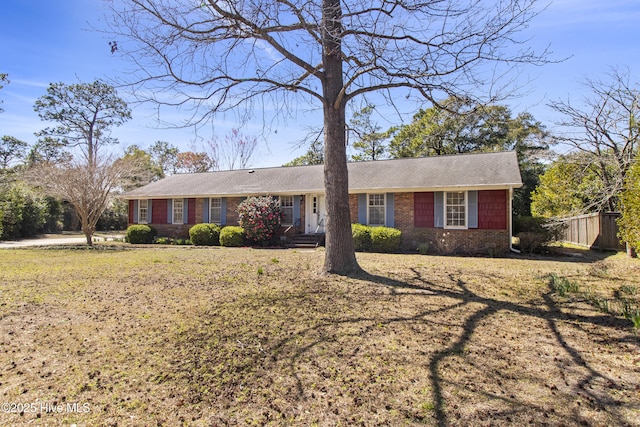 single story home with brick siding and fence