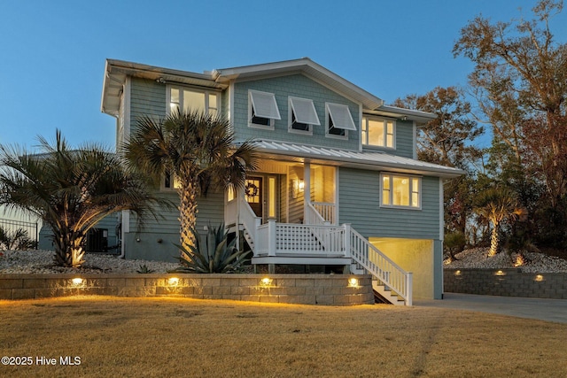 view of front of home with stairs, a front yard, and a porch