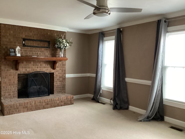 unfurnished living room featuring a wealth of natural light, visible vents, carpet floors, and ornamental molding