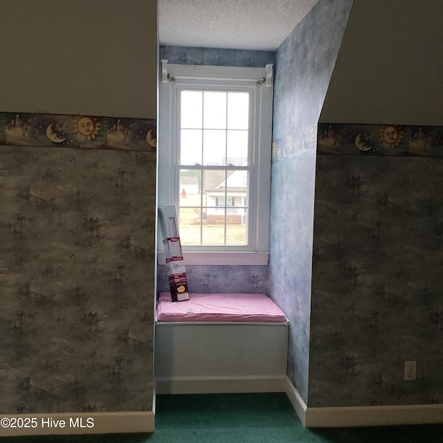 bathroom with baseboards, plenty of natural light, and a textured ceiling