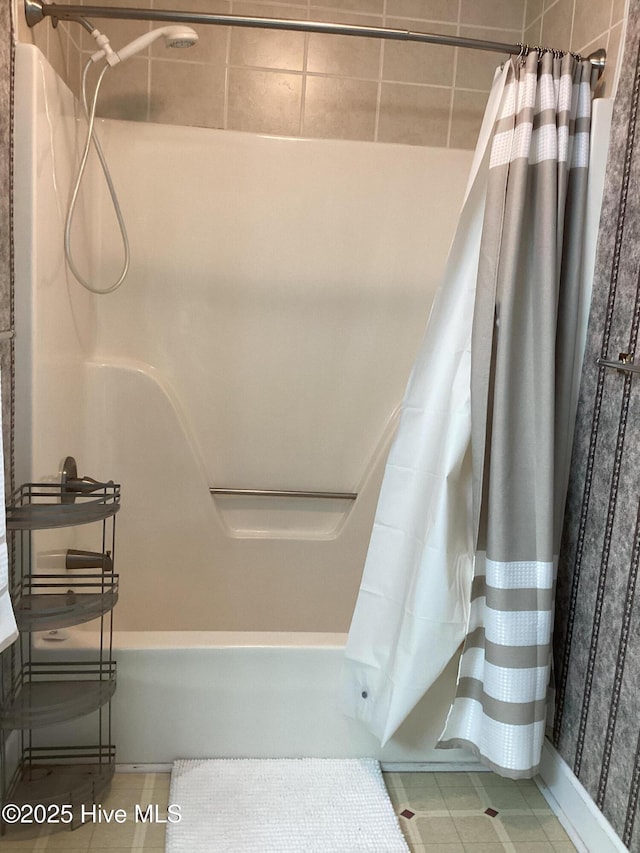 bathroom with tile patterned flooring and shower / tub combo