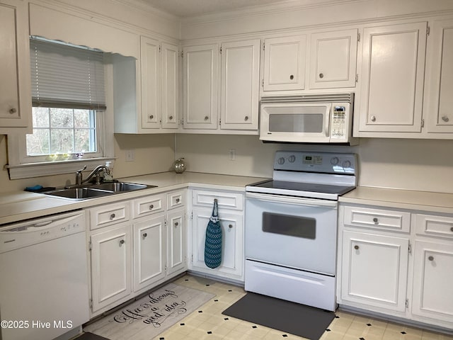 kitchen featuring white cabinetry, white appliances, light countertops, and a sink