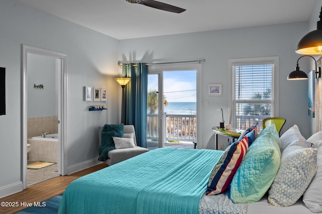 bedroom featuring access to exterior, ensuite bathroom, ceiling fan, wood finished floors, and baseboards