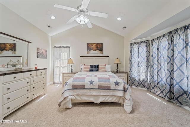 bedroom featuring visible vents, lofted ceiling, light colored carpet, and a ceiling fan