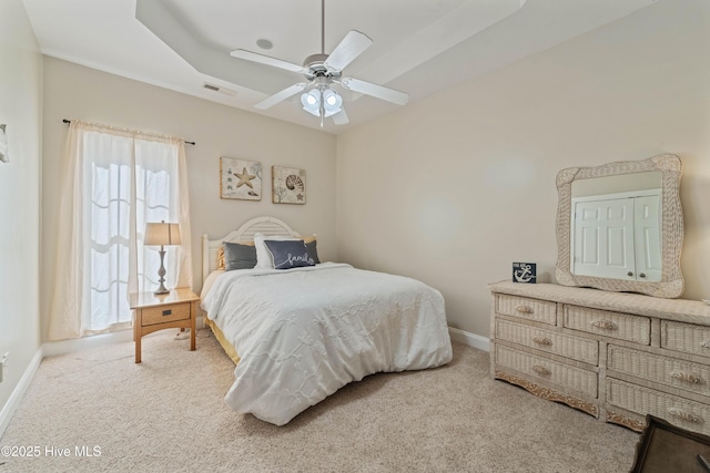 bedroom with visible vents, ceiling fan, baseboards, carpet, and a raised ceiling