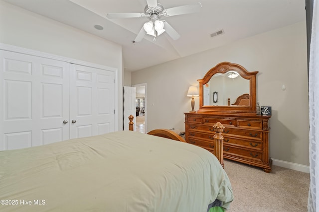 bedroom with a ceiling fan, baseboards, visible vents, a closet, and light carpet