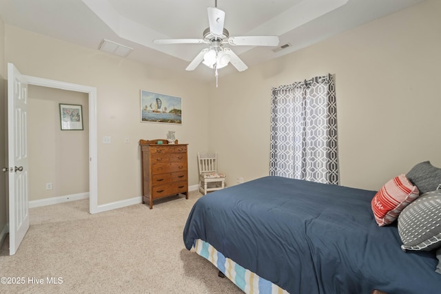 bedroom with visible vents, baseboards, light colored carpet, and ceiling fan