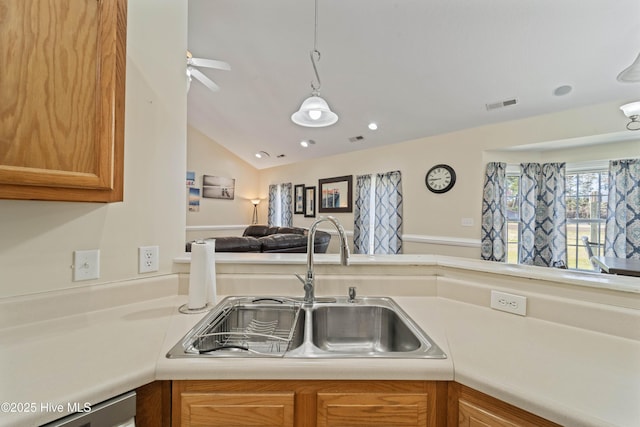 kitchen featuring visible vents, lofted ceiling, a sink, light countertops, and open floor plan