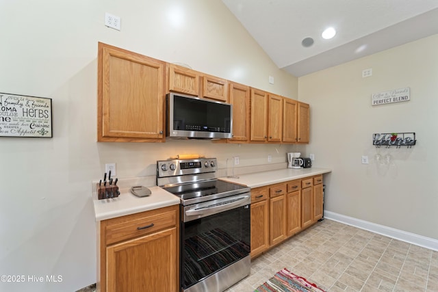 kitchen with baseboards, light countertops, vaulted ceiling, recessed lighting, and appliances with stainless steel finishes