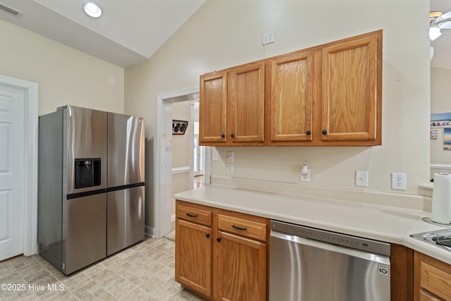 kitchen with visible vents, lofted ceiling, appliances with stainless steel finishes, and light countertops