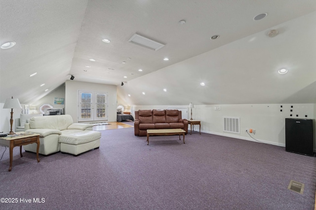 living area with visible vents, baseboards, carpet flooring, and vaulted ceiling